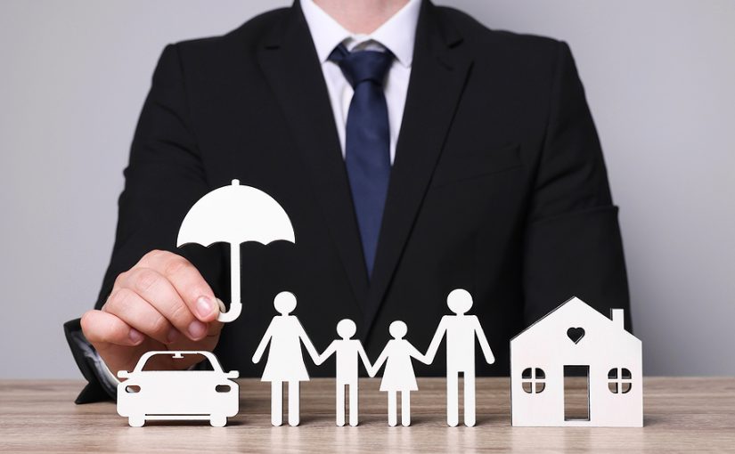 Man in suit holding umbrella over cutouts of a car, house, and family.