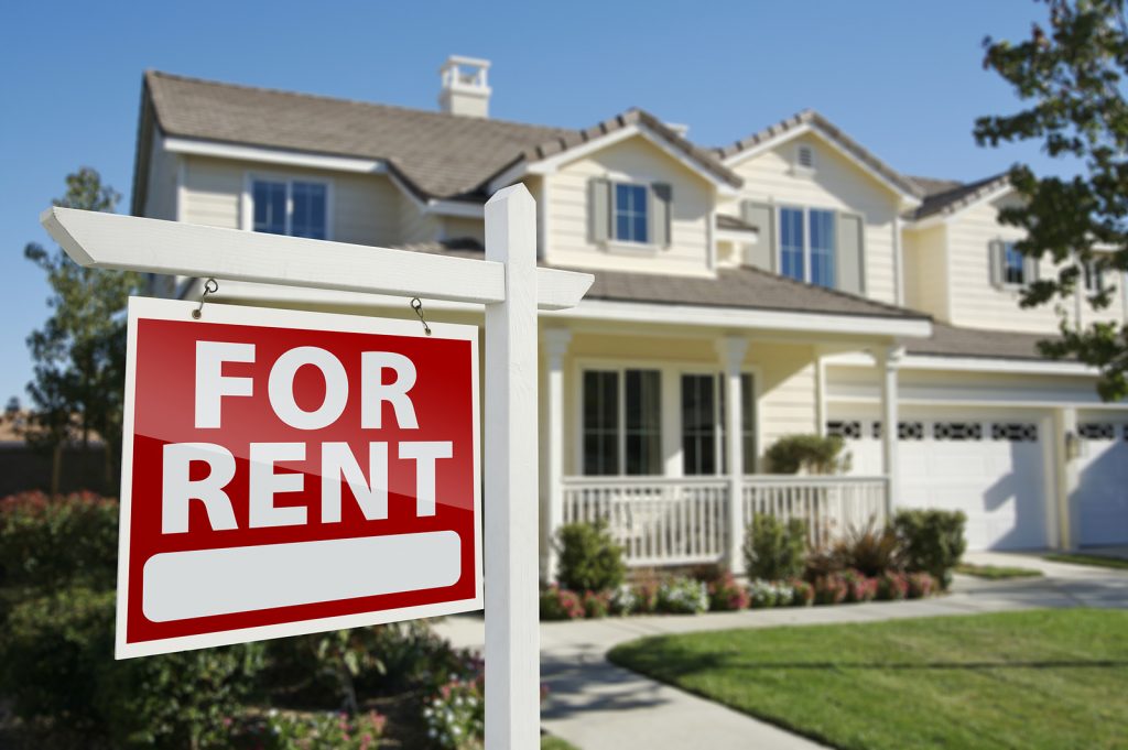 House with red For Rent sign hanging outside.