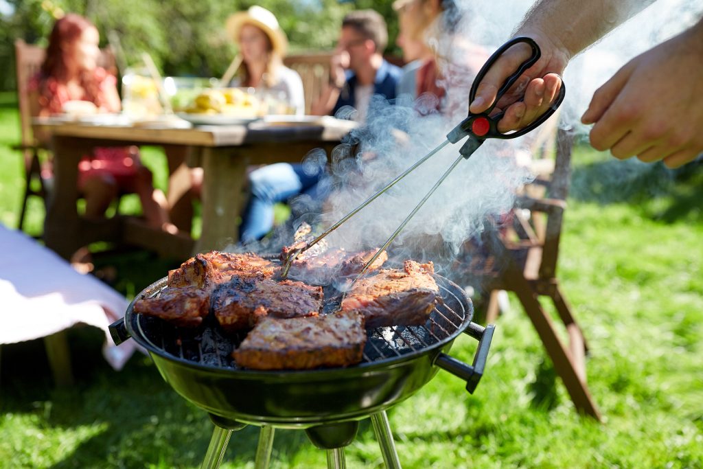 Group of friends and family enjoying a summer barbeque.