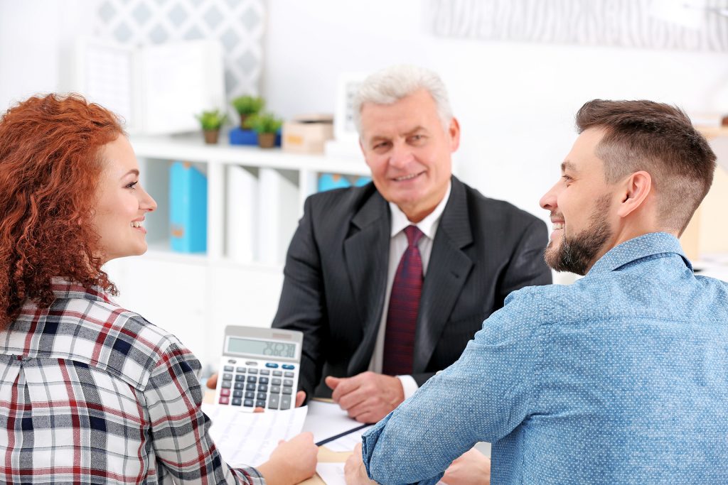 Couple meets with insurance agent to calculate a quote.