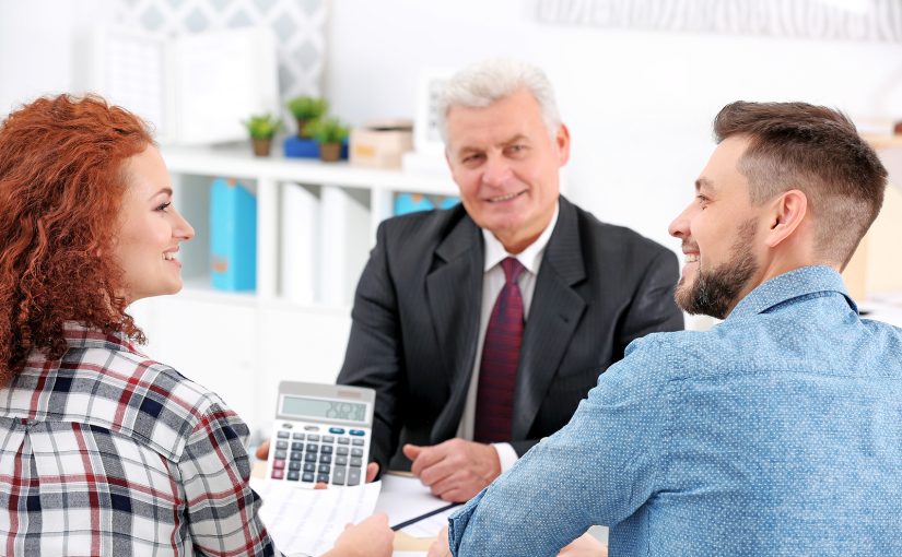 Couple meets with insurance agent to calculate a quote.