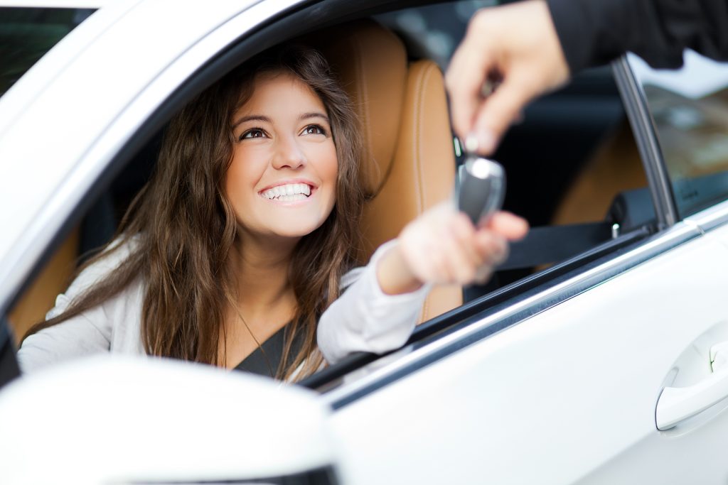 College student receiving keys to a car.