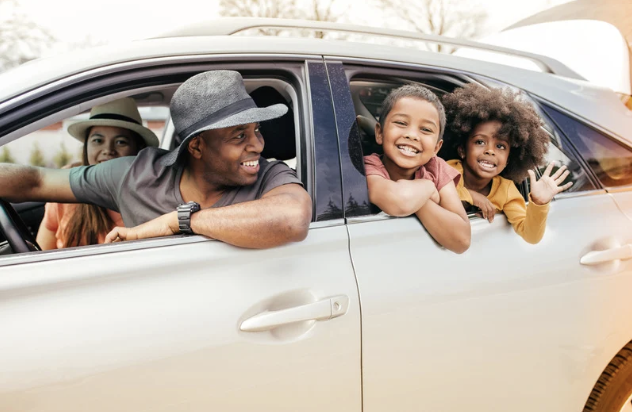 Family driving away in their car, ready for vacation.