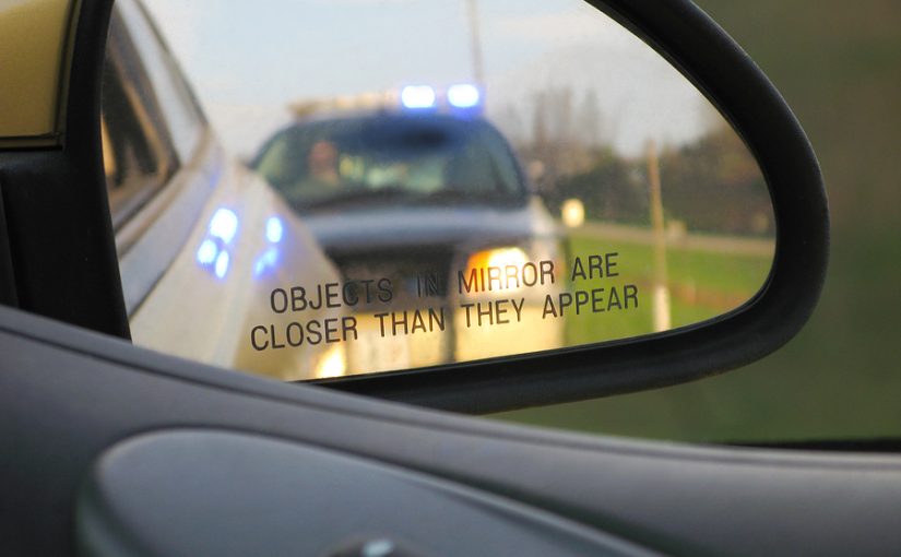 Car pulled over by a police officer for a traffic violation.