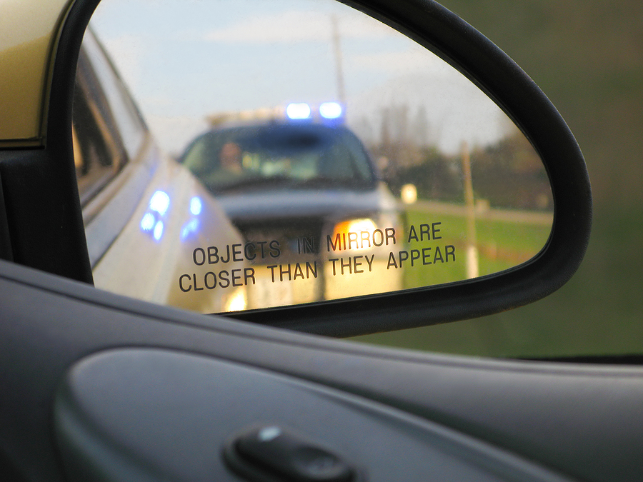 Car pulled over by a police officer for a traffic violation.