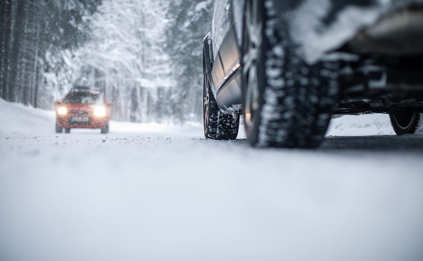 Two cars passing in the snow.