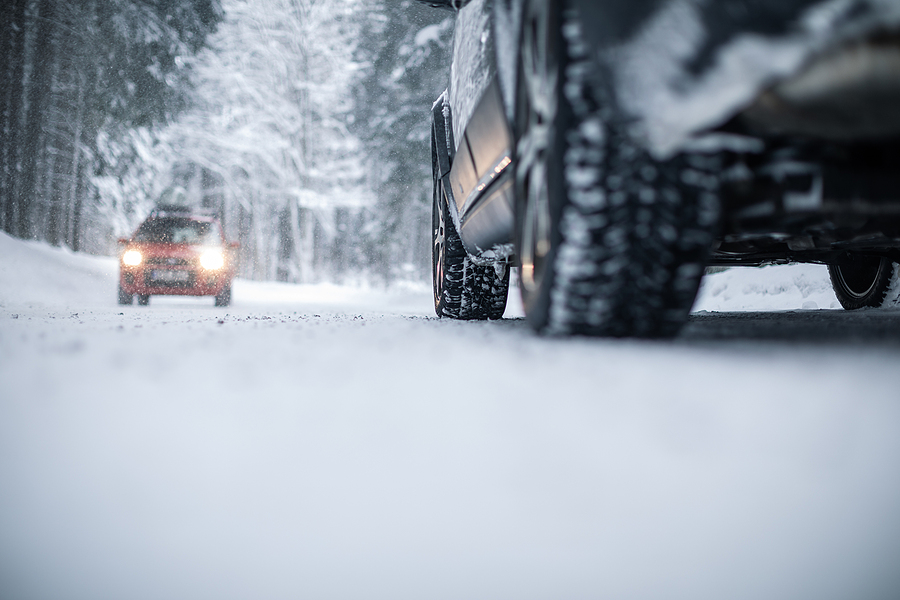 Two cars passing in the snow.